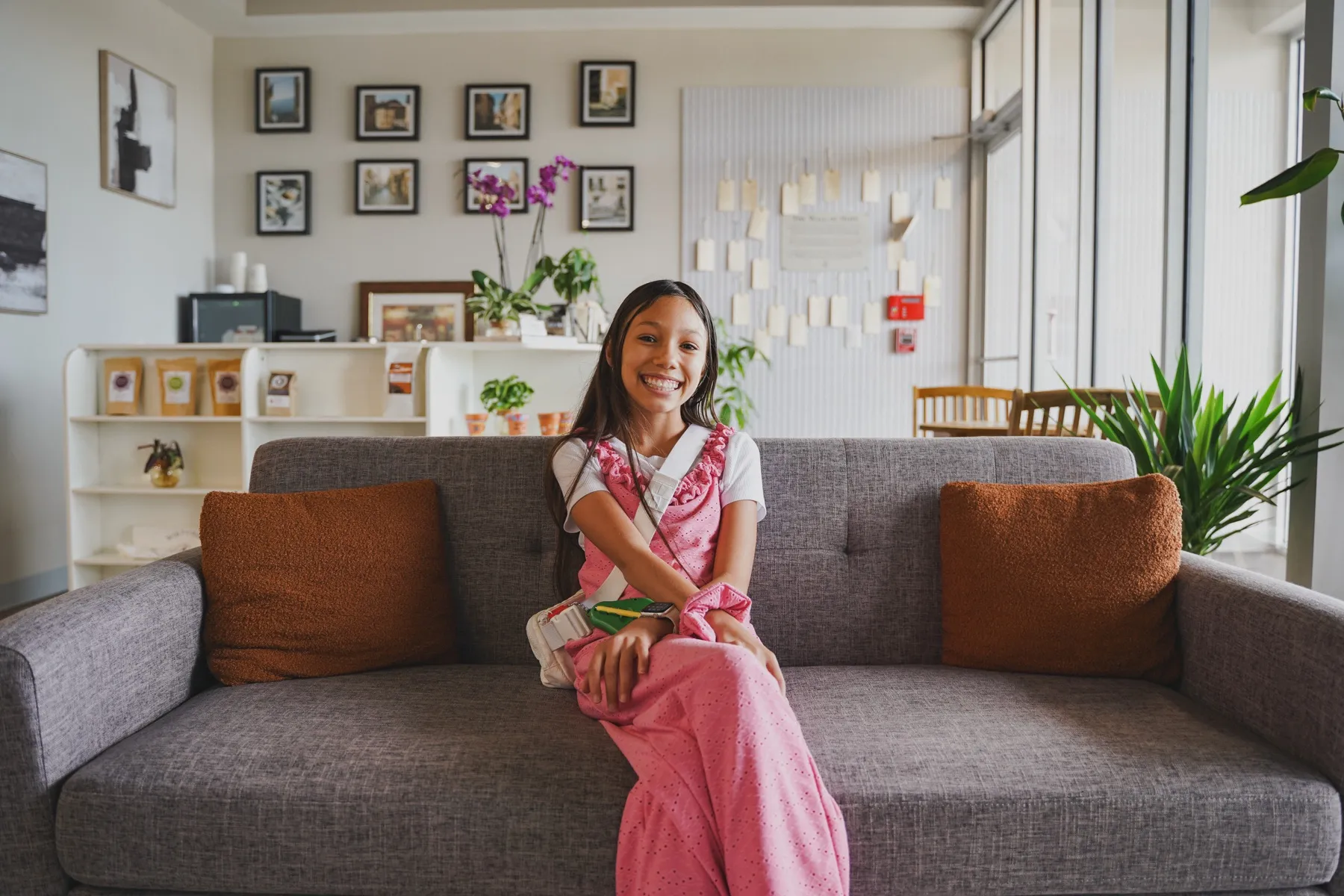 A young patient smiling in the Wiktorski Orthodontics lobby