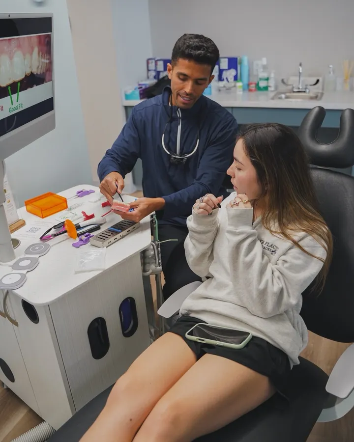 Dr. Wiktorski reviewing an aligner fit model with a patient